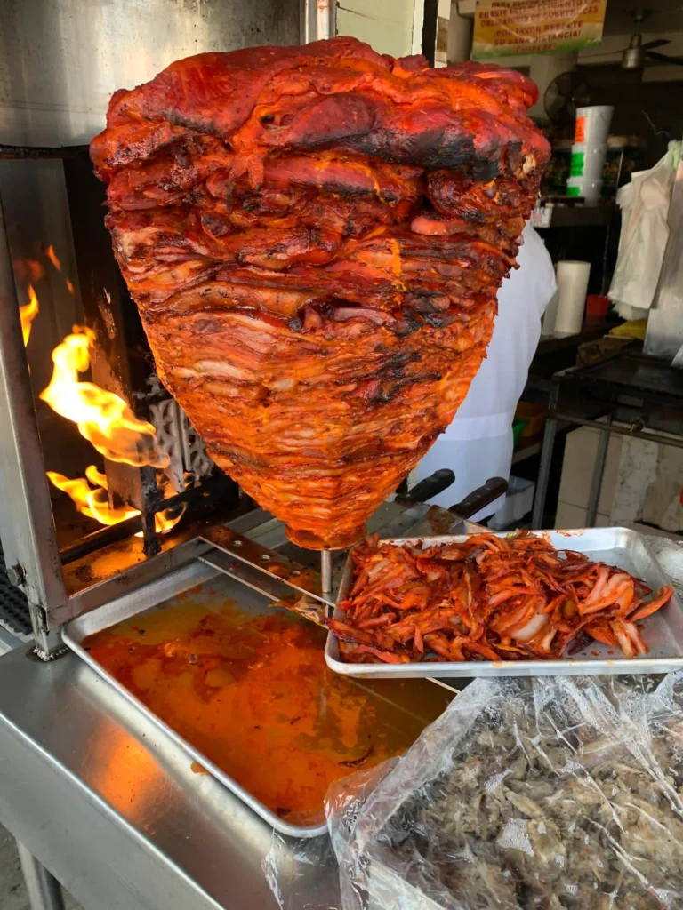 al pastor meat cooking on vertical spit