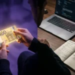 Comparison of receiving money in a dream vs real-world planning on a desk with a laptop.